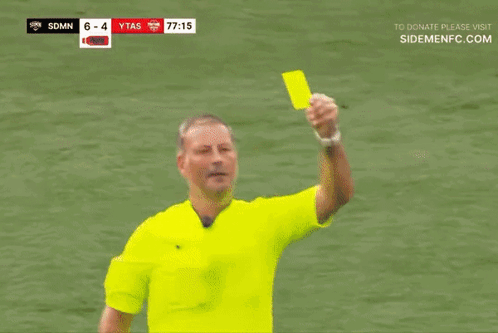 A Referee Giving A Yellow Card To A Player In A Red Shirt GIF