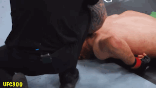 A Referee Is Kneeling Down Next To A Fighter With The Ufc300 Logo On The Bottom Right GIF
