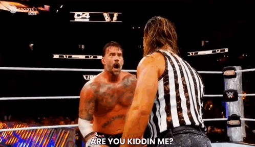A Referee Is Standing Next To A Wrestler In A Wrestling Ring And Asking Him If He Is Kidding Him . GIF