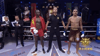 A Referee Stands Between Two Boxers One Of Whom Is Wearing A Pereira Shirt GIF