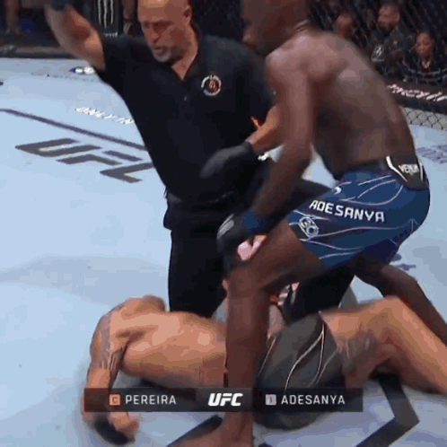 A Referee Stands Between Two Fighters In A Ufc Fight GIF