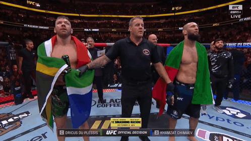 A Referee Stands Between Two Fighters In A Ufc Ring GIF