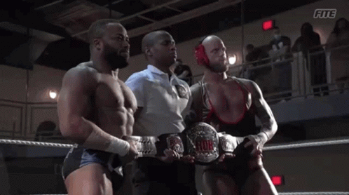 A Referee Stands Between Two Wrestlers In A Wrestling Ring With The Word Fite On The Bottom GIF