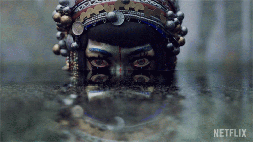 A Reflection Of A Woman 'S Face In A Body Of Water With Netflix Written On The Bottom GIF
