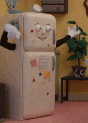 A Refrigerator With A Face And Arms Is In A Room GIF