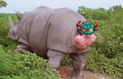 A Rhino Wearing A Costume With Horns And A Pink Nose GIF
