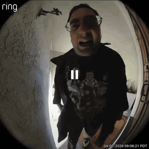 A Ring Doorbell Shows A Man Wearing Glasses And A Black Jacket GIF