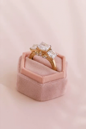 A Ring In A Pink Box With The Words Explore Golden Deals GIF