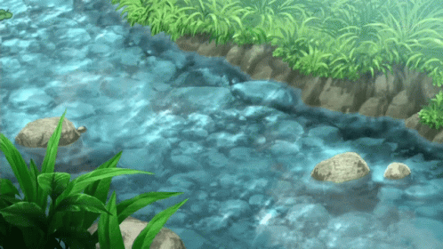 A River Flowing Through A Grassy Area With Rocks In The Water GIF