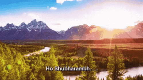 A River Runs Through A Lush Green Forest With Mountains In The Background And The Words Ho Shubharambh In The Foreground GIF