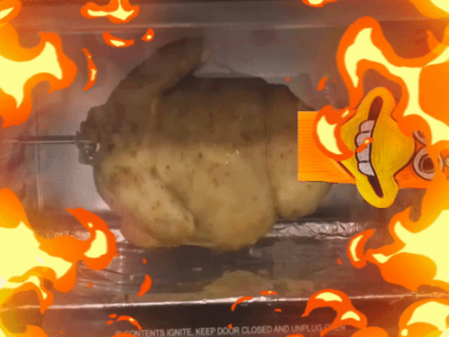 A Roasted Chicken In An Oven With Flames Surrounding It GIF
