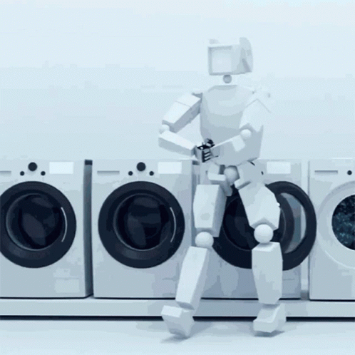 A Robot Is Standing In Front Of A Row Of Washers GIF