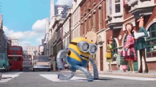 A Robot Minion Is Walking Down A Street GIF