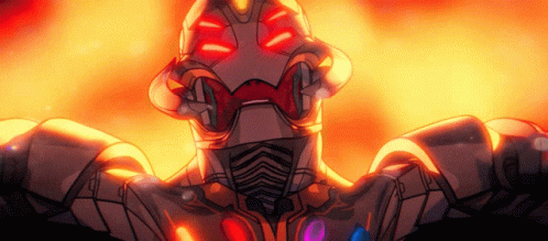 A Robot With Red Eyes Is Standing In Front Of A Fire Background GIF