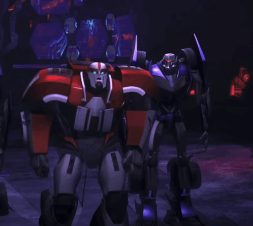 A Robot With The Number 1 On It Stands In A Dark Room GIF