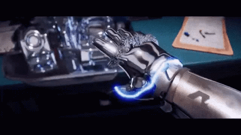 A Robotic Arm With A Blue Light Coming Out Of It 'S Hand . GIF