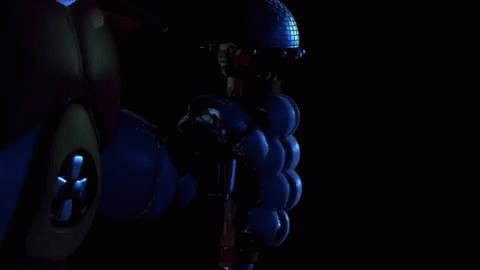 A Robotic Hand Is Giving A Thumbs Up In The Dark . GIF