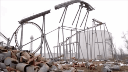 A Roller Coaster Is Being Built In The Middle Of A Pile Of Junk GIF