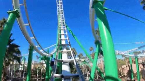 A Roller Coaster With Green Poles And A Blue Sky In The Background . GIF