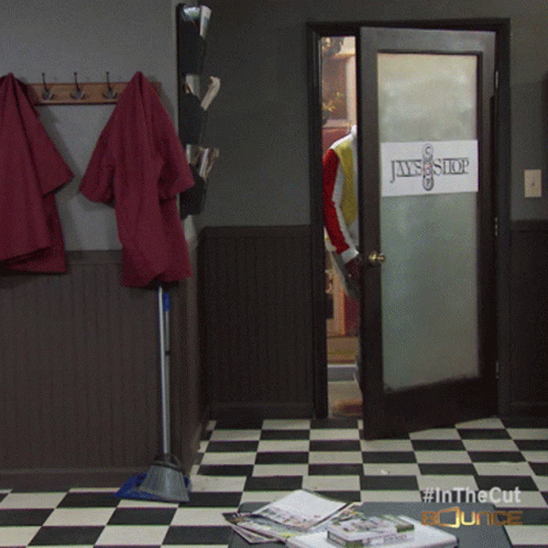 A Room With A Checkered Floor And A Door That Says Jaws Shop GIF