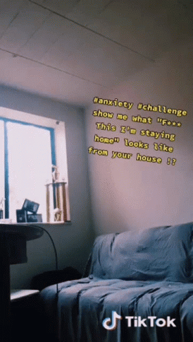 A Room With A Couch And A Window With A Tik Tok Sticker On The Wall GIF