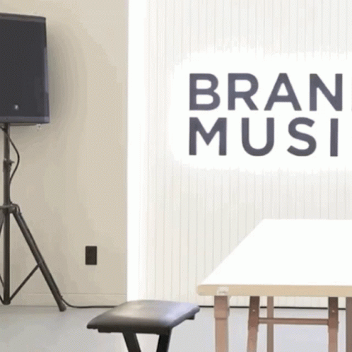 A Room With A Sign That Says Bran Music On It GIF