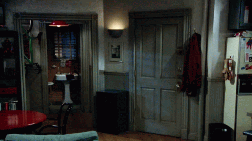 A Room With A Sink And A Refrigerator With A Picture Of Superman On It GIF