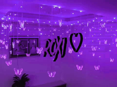 A Room With Purple Lights Hanging From The Ceiling And A Sign That Says Xoxo GIF