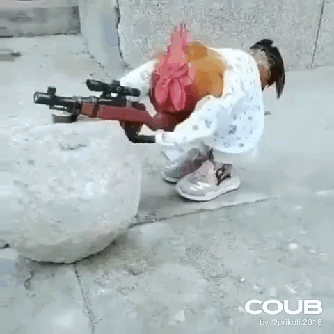 A Rooster Is Holding A Gun Next To A Snowball On The Sidewalk . GIF