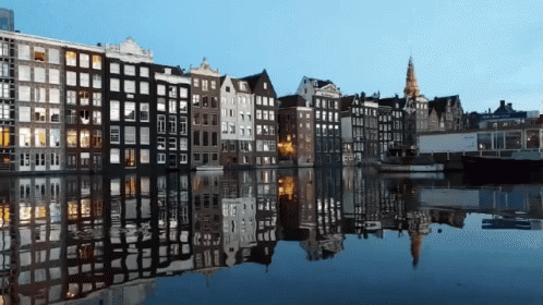 A Row Of Buildings Along A Body Of Water GIF