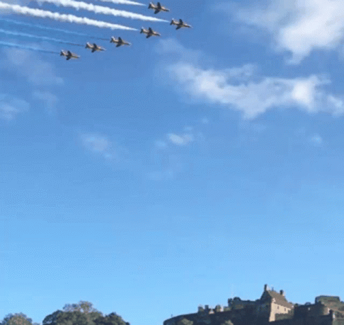 A Row Of Jets Flying In Formation With Red White And Blue Smoke Trails GIF
