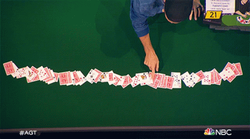 A Row Of Playing Cards On A Table With The Number 21 On The Table GIF