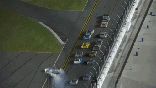 a row of race cars are lined up on a race track and one of them has the word ford on the side