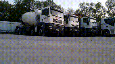 A Row Of Trucks Are Parked In A Parking Lot Including One That Says Man GIF