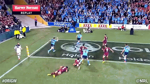 A Rugby Game Is Being Played In A Stadium With Advertisements For Harvey Norman In The Stands GIF