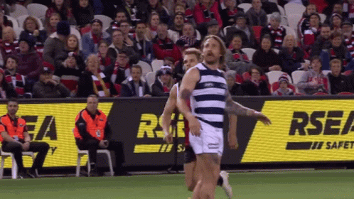 A Rugby Game Is Being Played In Front Of An Rsea Sign GIF
