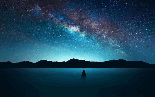 A Sailboat In The Middle Of A Lake With Mountains In The Background GIF