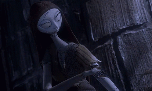 A Sally Doll From The Nightmare Before Christmas Talks On A Cell Phone GIF