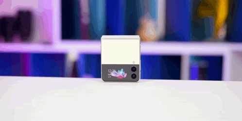 A Samsung Phone Is Sitting On A White Table With A Blurry Background GIF