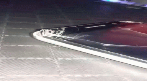 A Samsung Phone With A Cracked Screen Is Laying On A Table GIF