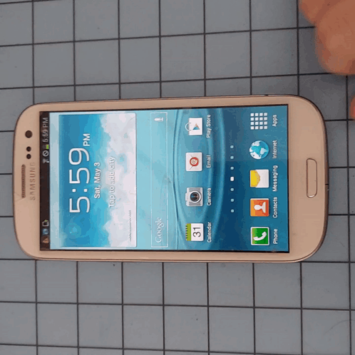 A Samsung Phone With The Time Of 5:59 On The Screen GIF