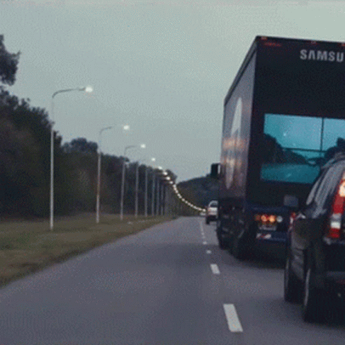A Samsung Truck Is Driving Down The Highway GIF