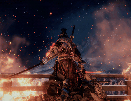 A Samurai With A Sword Stands In Front Of A Fire GIF