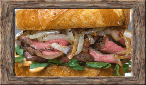 A Sandwich In A Wooden Frame With A Lot Of Meat And Onions GIF
