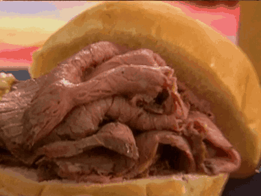 A Sandwich With Sliced Roast Beef On A Bun GIF