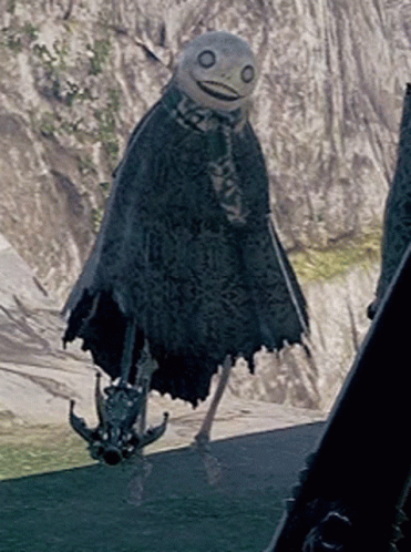 A Scarecrow Is Standing In Front Of A Mountain And Holding A Sword GIF