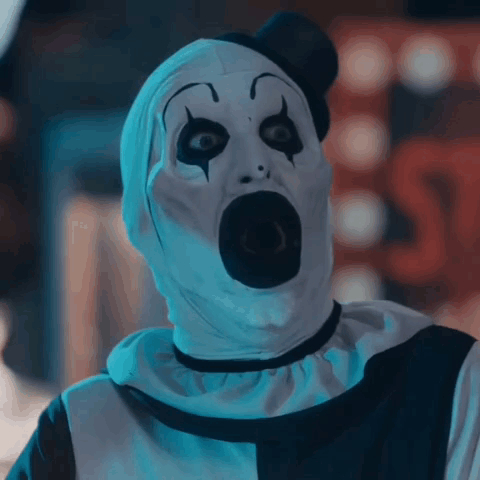 A Scary Clown With A Shocked Look On His Face GIF