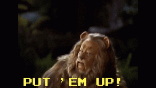 A Scene From The Wizard Of Oz With The Words Put Em Up Written On The Screen GIF