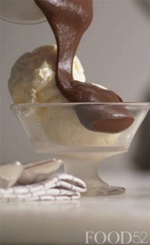 A Scoop Of Ice Cream Is Being Poured Into A Bowl With Food52 Written On The Bottom GIF