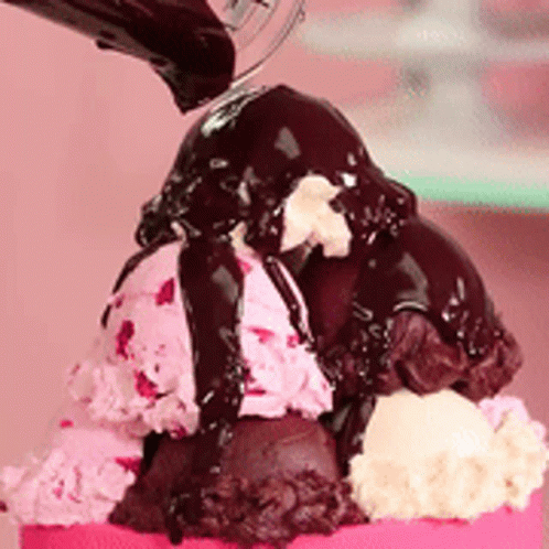 A Scoop Of Ice Cream With Chocolate Sauce On Top GIF
